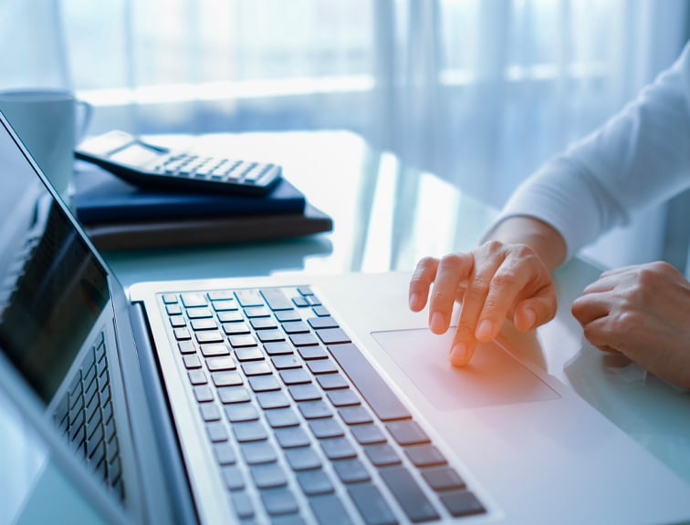 Hand of women typing on a laptop keyboard